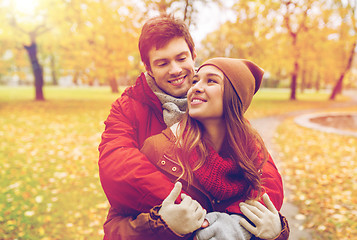 Image showing happy young couple hugging in autumn park