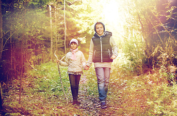 Image showing two happy kids walking along forest path