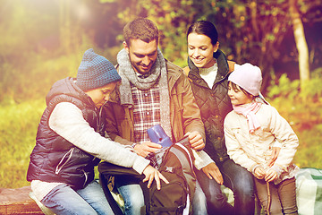 Image showing happy family with backpack and thermos at camp