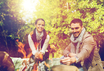 Image showing happy couple roasting marshmallow over camp fire