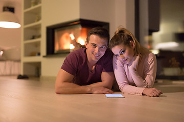 Image showing Young Couple using digital tablet on cold winter night