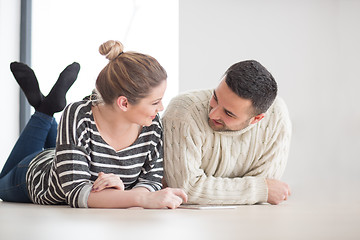 Image showing Young Couple using digital tablet on cold winter day