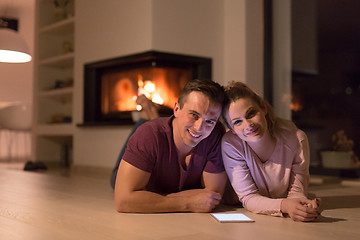 Image showing Young Couple using digital tablet on cold winter night