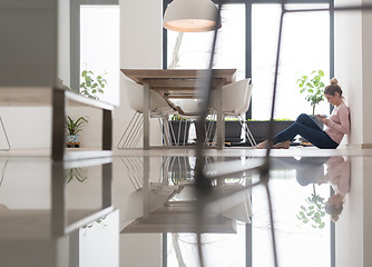 Image showing young woman using tablet computer on the floor