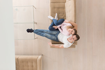 Image showing Young couple on the sofa watching television top view