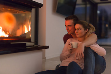 Image showing happy couple in front of fireplace