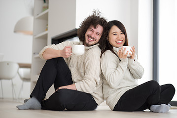 Image showing happy multiethnic couple  in front of fireplace