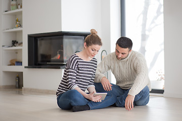 Image showing Young Couple using digital tablet on cold winter day