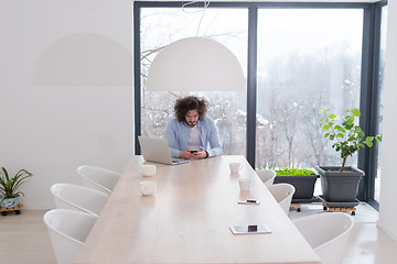 Image showing Young casual businessman using smartphone