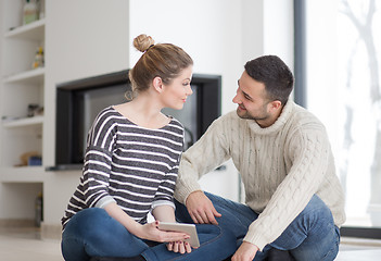 Image showing Young Couple using digital tablet on cold winter day