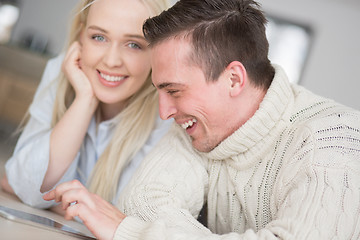 Image showing Young Couple using digital tablet on cold winter day