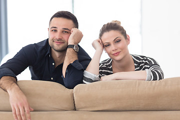 Image showing Portrait of young couple sitting on sofa