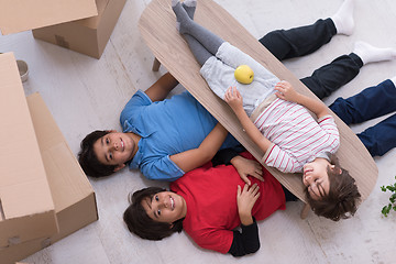 Image showing boys with cardboard boxes around them top view