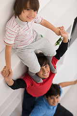 Image showing young boys posing line up piggyback top view