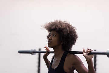 Image showing black woman lifting empty bar