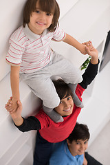 Image showing young boys posing line up piggyback top view