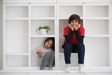 Image showing young boys posing on a shelf