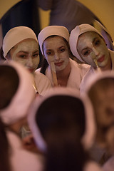 Image showing women putting face masks in the bathroom