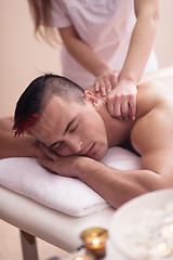 Image showing young man having a back massage