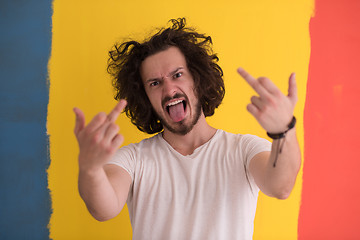 Image showing young man with funny hair over color background