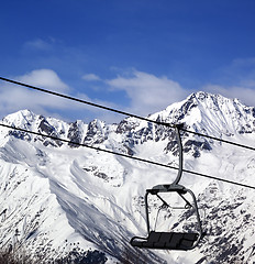 Image showing Chair-lift in snow winter mountains at nice sun day