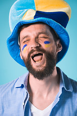 Image showing The football fan over blue