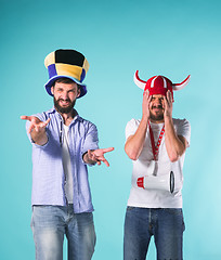 Image showing The two football fans over blue