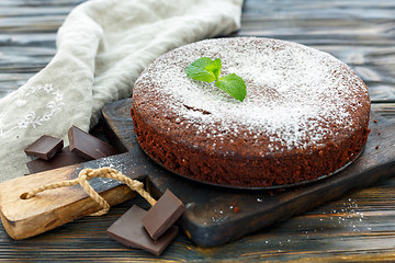 Image showing Delicious chocolate cake,dusted with powdered sugar.