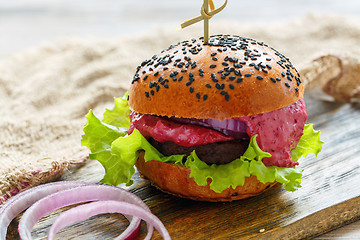 Image showing Homemade burger with beef meat and berry sauce.