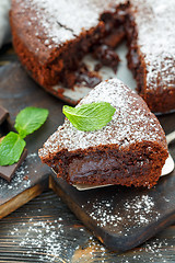 Image showing Piece of chocolate cake dusted with powdered sugar.