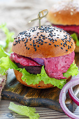 Image showing Burger with beef meat, salad and berry sauce.