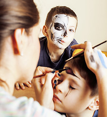 Image showing little cute child making facepaint on birthday party, zombie Apo