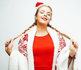 Image showing young pretty happy smiling blond woman on christmas in santas red hat and holiday decorated plaid, lifestyle people concept