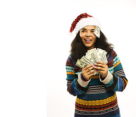 Image showing cute young girl in santas red hat with money isolated