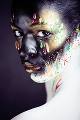 Image showing woman with creative makeup closeup like drops of colors, facepai