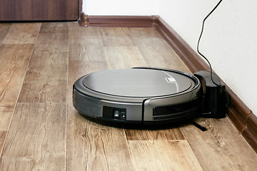 Image showing robot vacuum cleaner on the parquet floor