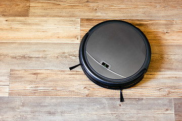 Image showing robot vacuum cleaner on the parquet floor