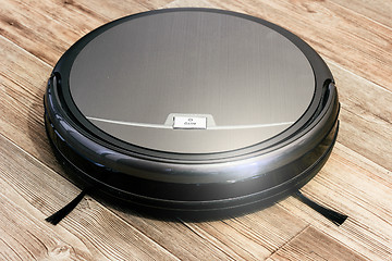 Image showing robot vacuum cleaner on the parquet floor