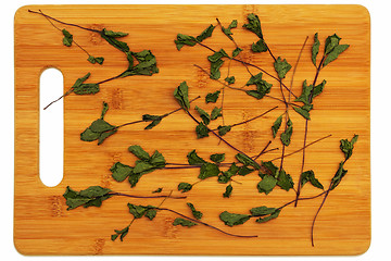 Image showing Dried mint on the board.