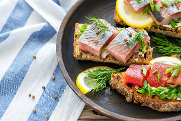 Image showing Homemade bread with cheese, herring and green onions.