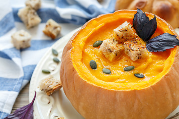 Image showing Pumpkin soup with croutons in a pumpkin closeup.