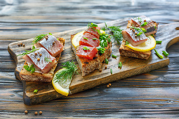 Image showing Toast with herring, caviar, green onion and dill.