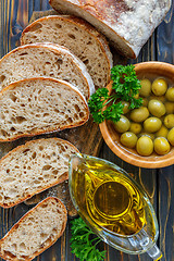 Image showing Homemade ciabatta with olive oil and olives.