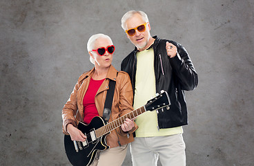 Image showing senior couple in sunglasses with electric guitar