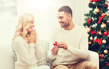 Image showing man giving woman engagement ring for christmas