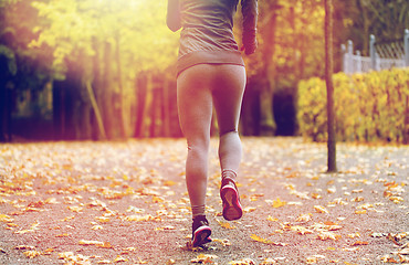 Image showing close up of young woman running in autumn park