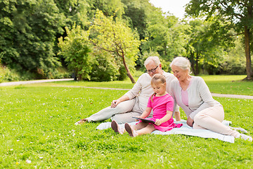 Image showing grandparents and granddaughter with tablet pc