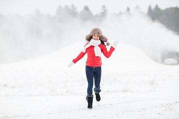 Image showing happy woman in winter fur hat outdoors