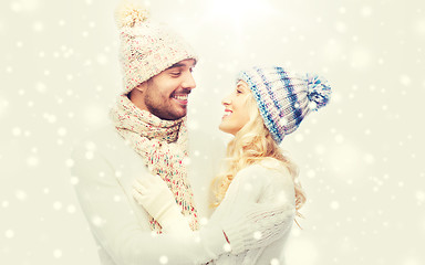 Image showing smiling couple in winter clothes hugging