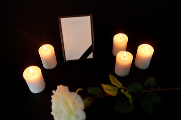 Image showing photo frame with black ribbon, flower and candles